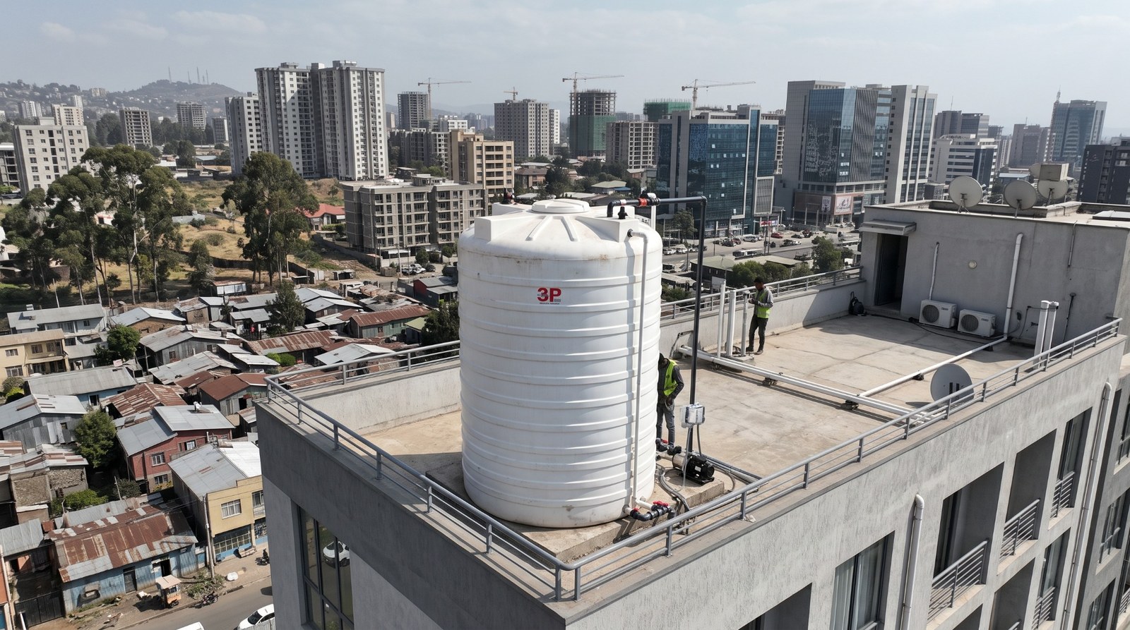 A plastic water storage tank installed on a rooftop in a city, illustrative scene